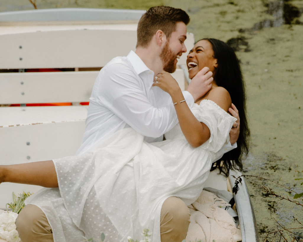Bride and groom laugh in boat at destination elopement in South Carolina