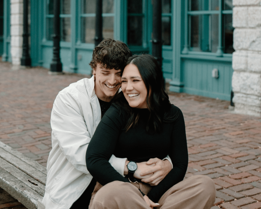 Couple laughs together in downtown Minneapolis engagement shoot