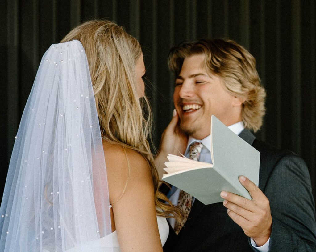 Groom grins at bride as they exchange vows in private