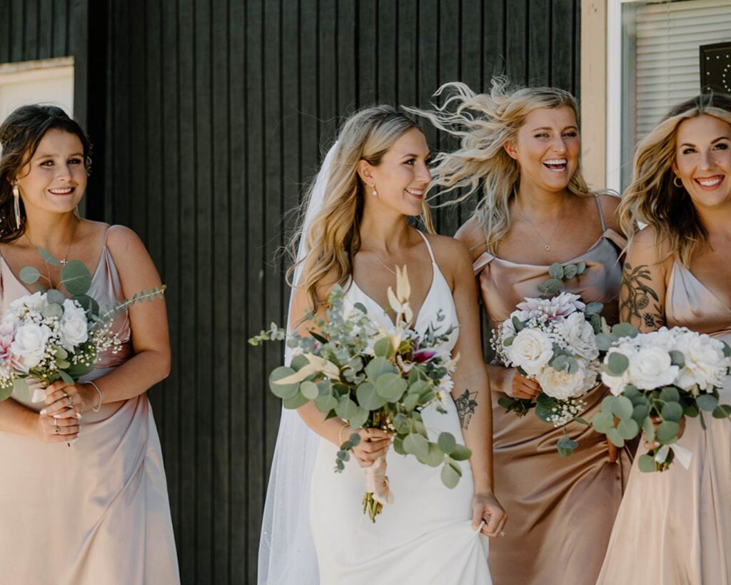 Bridal party walks down Main Street together with Trader Joe's floral arrangements in hand