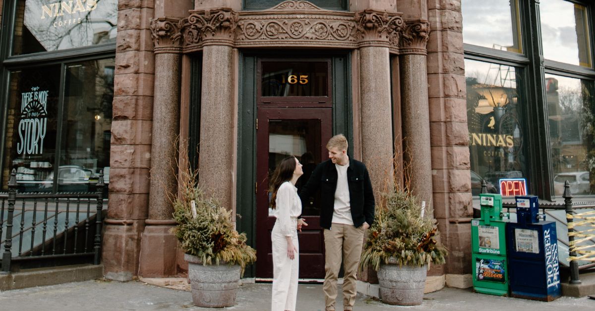 Romantic engagement photoshoot in front of Nina's Coffee Cafe in downtown Saint Paul.
