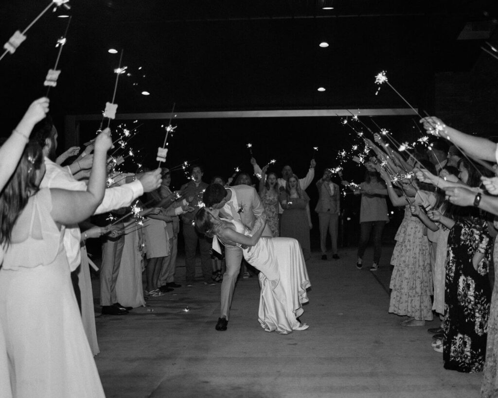 Bride and groom make sparkler exit at the end of their spring wedding.
