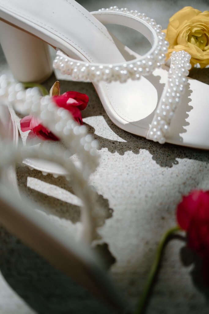 Bride's shoes and floral bouquet