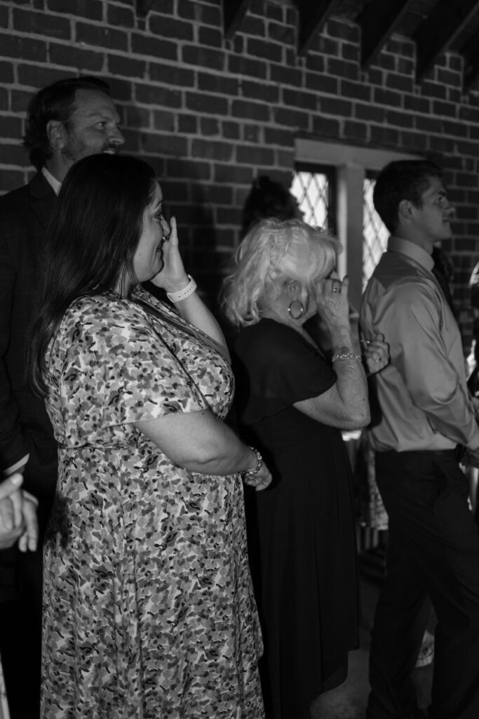 Garden wedding guests wipe their eyes in emotional first dance