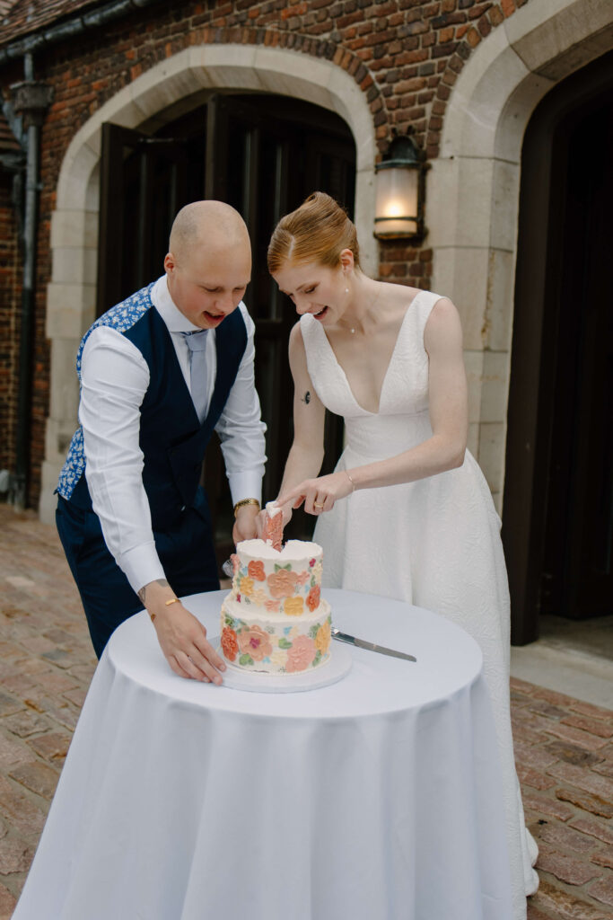 Bride and groom cut their garden wedding cake