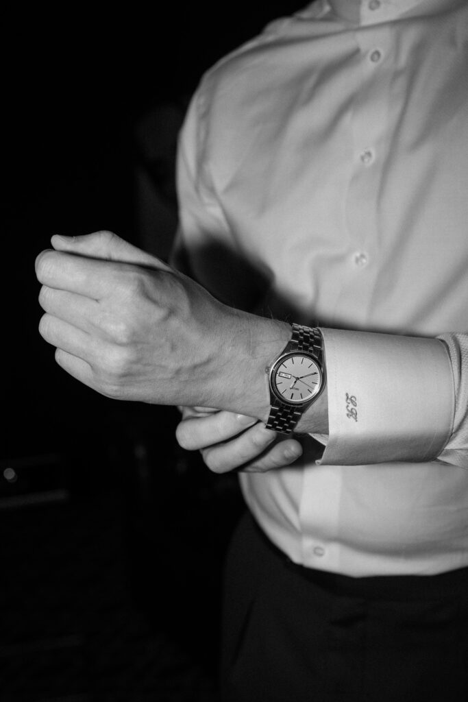 Groom puts his watch on his wrist