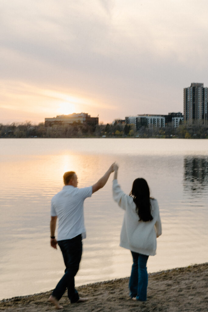 Couple dances along the sunset shore of Bde Mka Ska