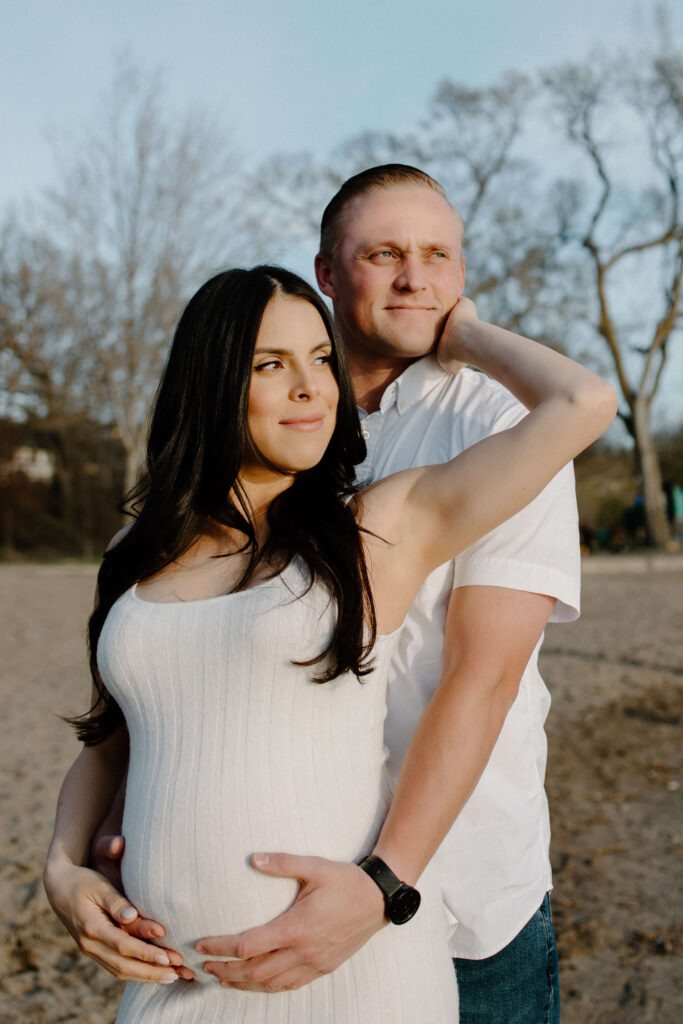 Minneapolis couple looks off into the distance in Bde Mka Ska maternity photoshoot